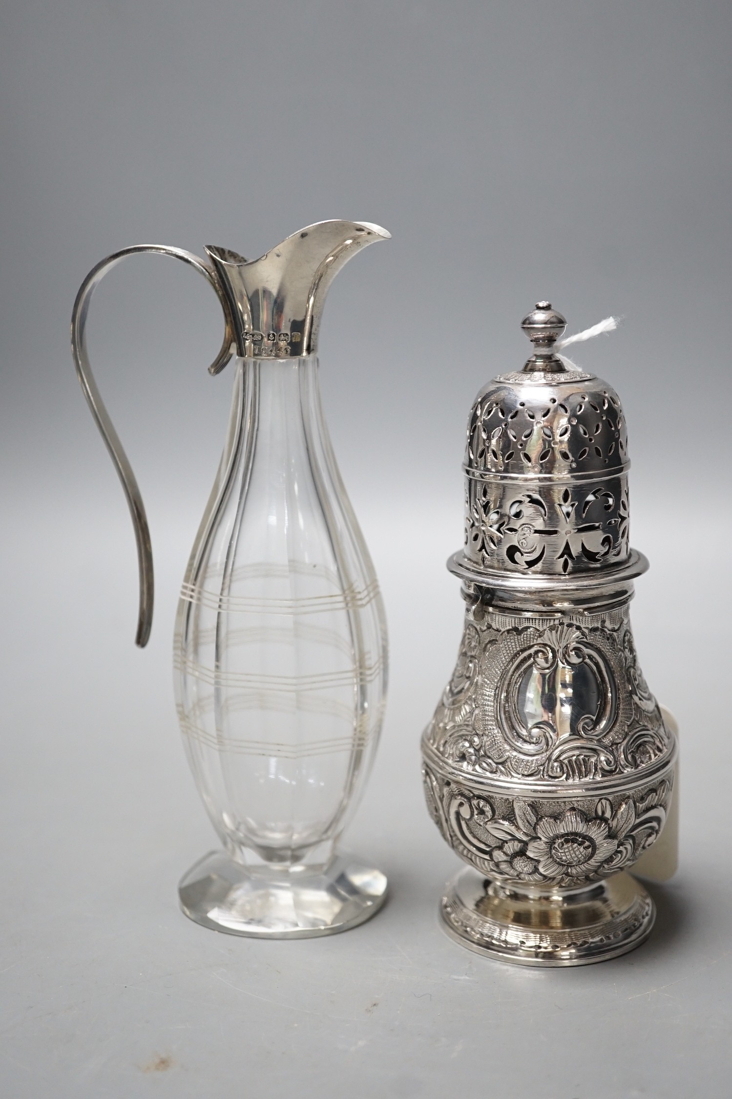 A late Victorian silver helmet shaped cream jug, a silver sugar bowl, a silver mustard pot, a silver mounted posy vase and a silver two handled bowl.